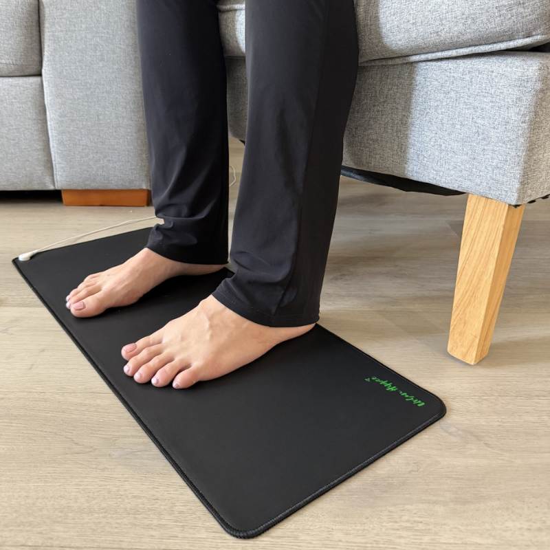 earthing & grounding mat being used on floor with feet on top. earthing & grounding mat being used on floor with feet on top.