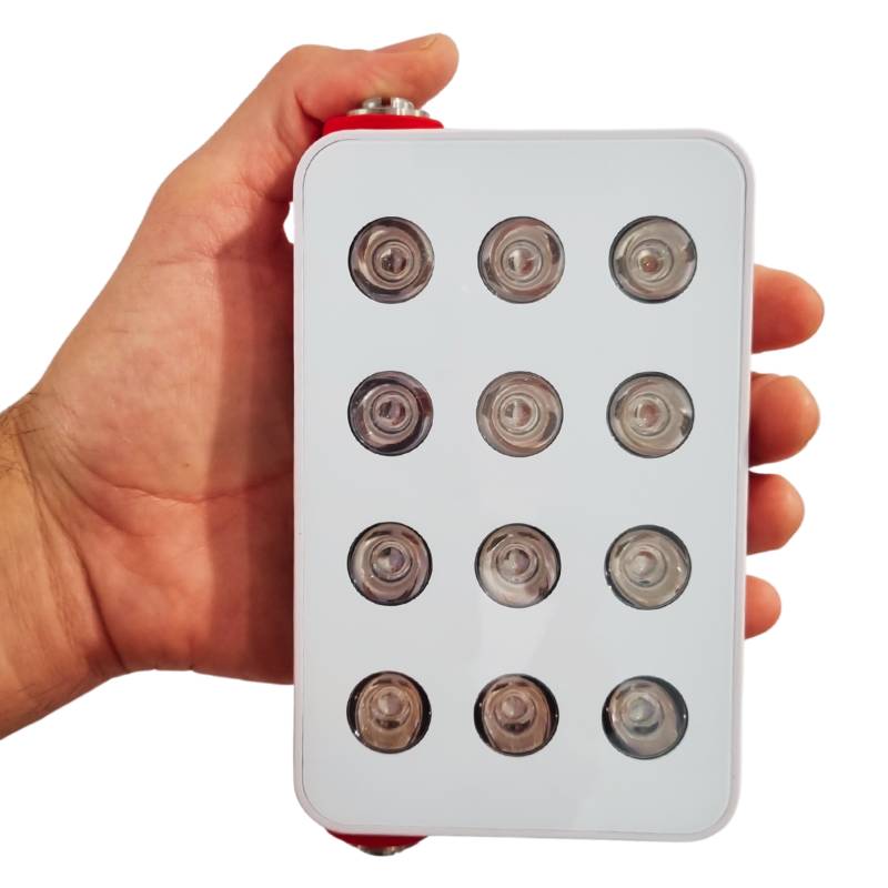 Red light therpay and infrared mini held with starp in hand. Red light therpay and infrared mini held with starp in hand.