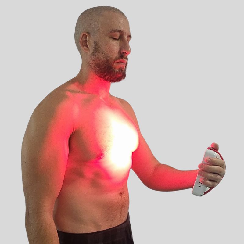 Red light therpay and infrared mini used on man with no shirt. Red light therpay and infrared mini used on man with no shirt.