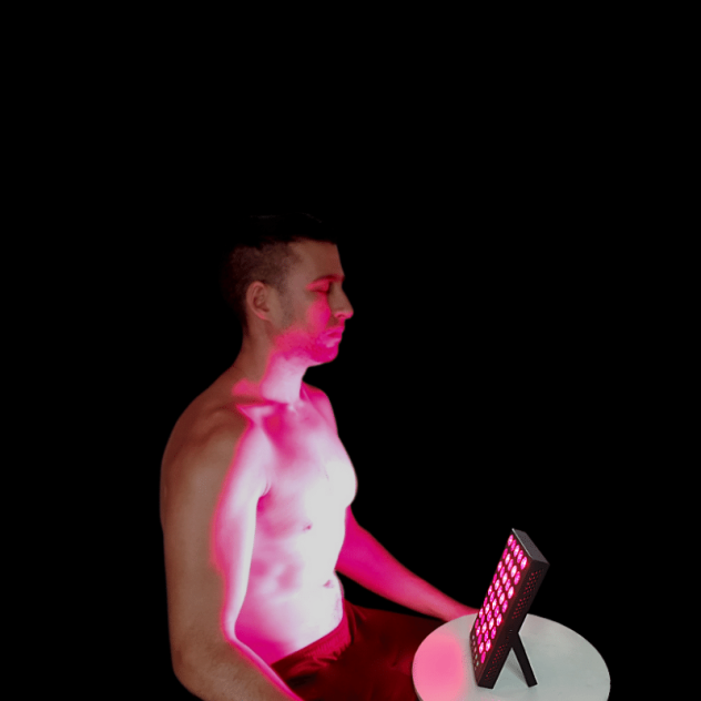 Red light therapy being used on body of man.
