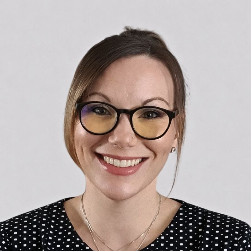 Woman wearing round black frame blue light blocking glasses with yellow lenses, shown in a clear front-facing studio portrait. Woman wearing round black frame blue light blocking glasses with yellow lenses, shown in a clear front-facing studio portrait.