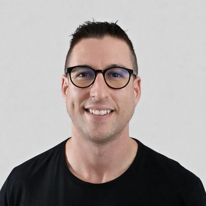 Man wearing round black frame blue light blocking glasses, shown in a clear front-facing studio portrait. Man wearing round black frame blue light blocking glasses, shown in a clear front-facing studio portrait.