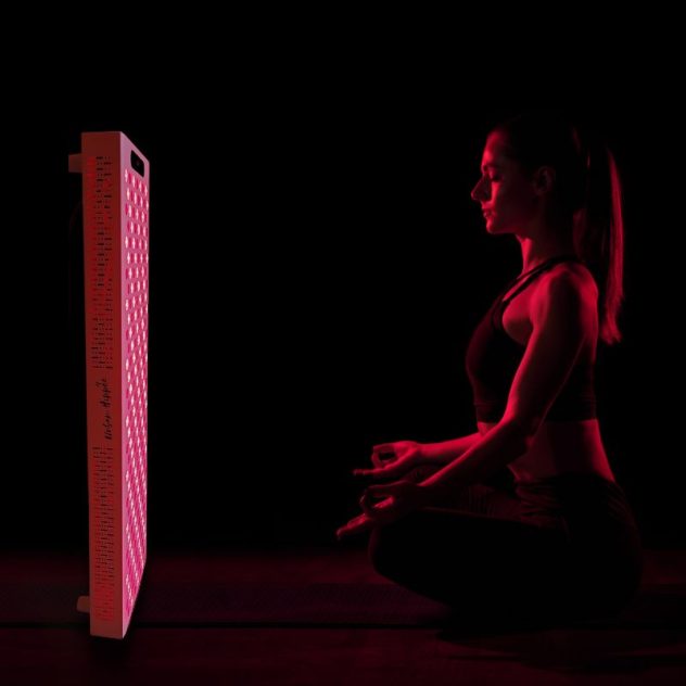 Red light therapy and infrared Proplus 1200 in front on lady meditating.