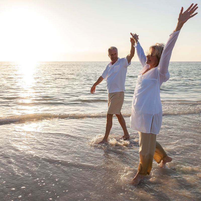 Earthing on the beach, young couple.