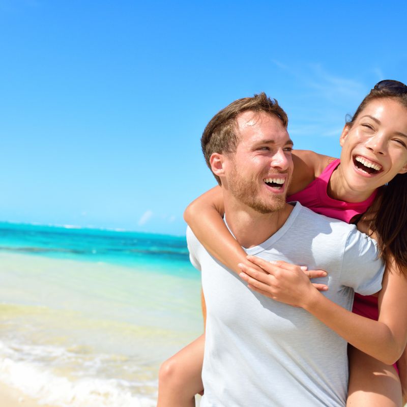 Earthing on the beach, young couple.