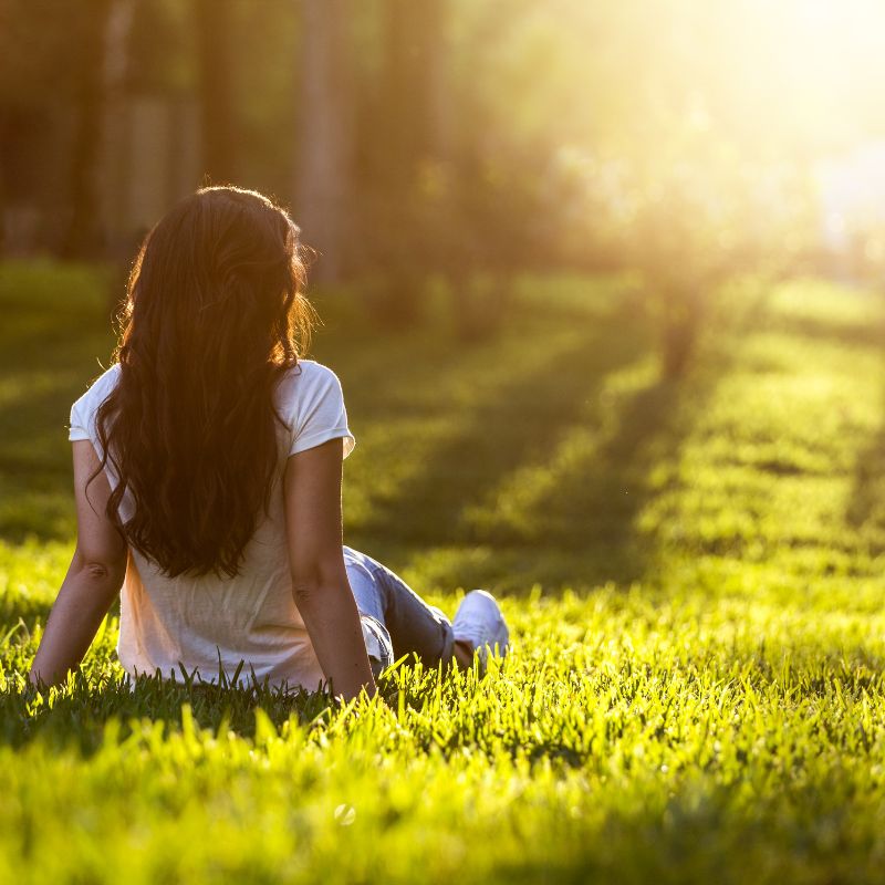 Earthing on grass and relaxing and grounding the body.