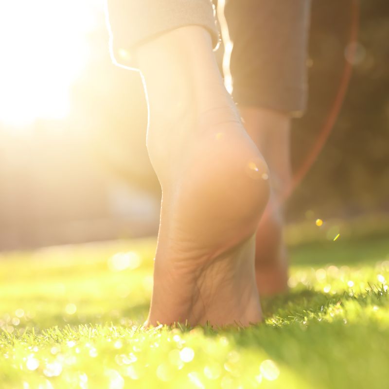 Earthing barefoot on grass and grounding the body.