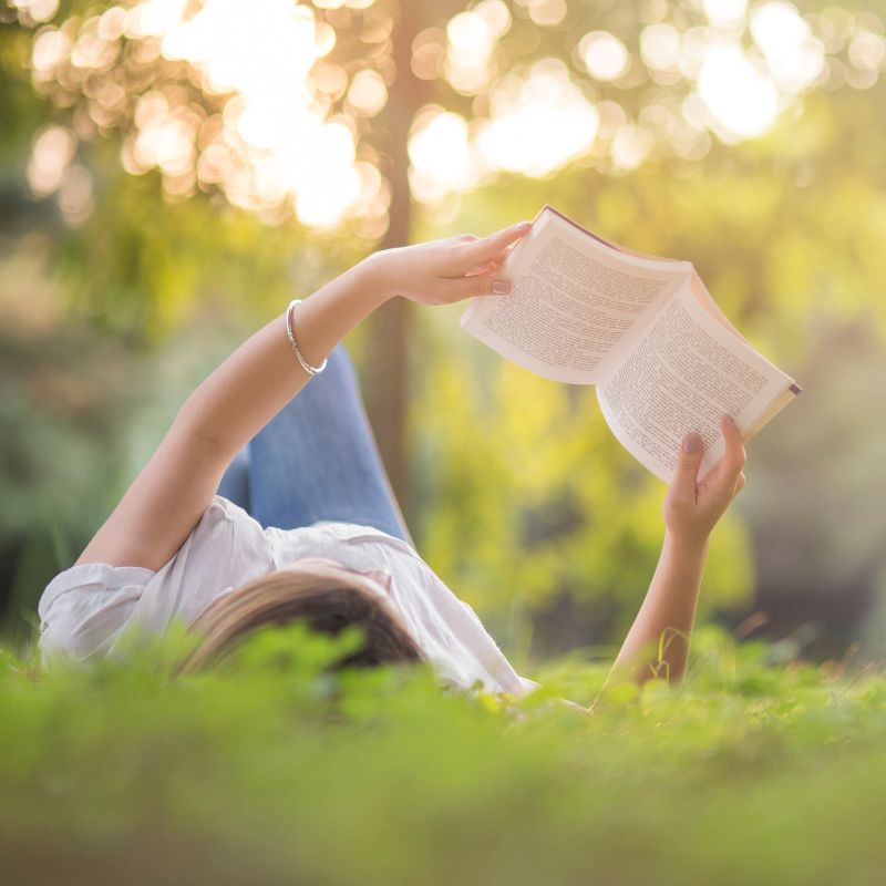 Grounding on the grass reading a book. 