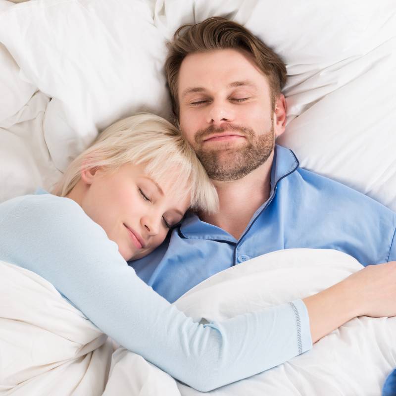 Couple sleeping on earthing sheet.