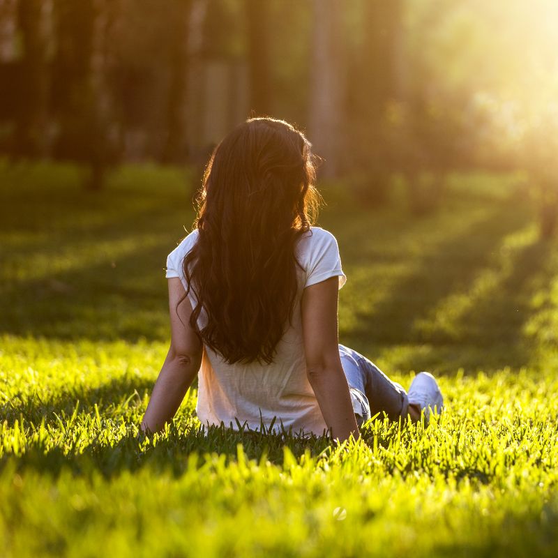 Relaxing on grass, grounding and earthing the body.