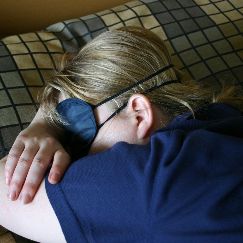 Lady laying down on a grounding sheet. 