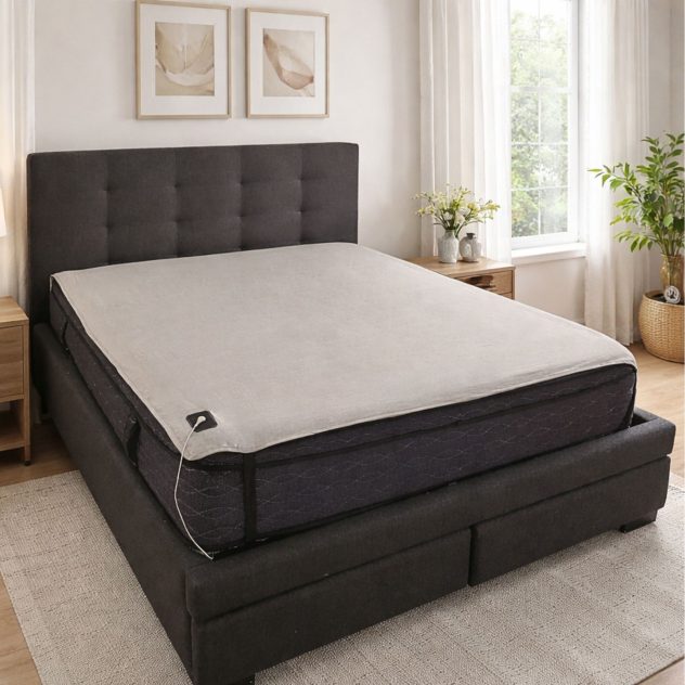 Grounding sheet underlay shown under fitted sheet for earthing while sleeping.