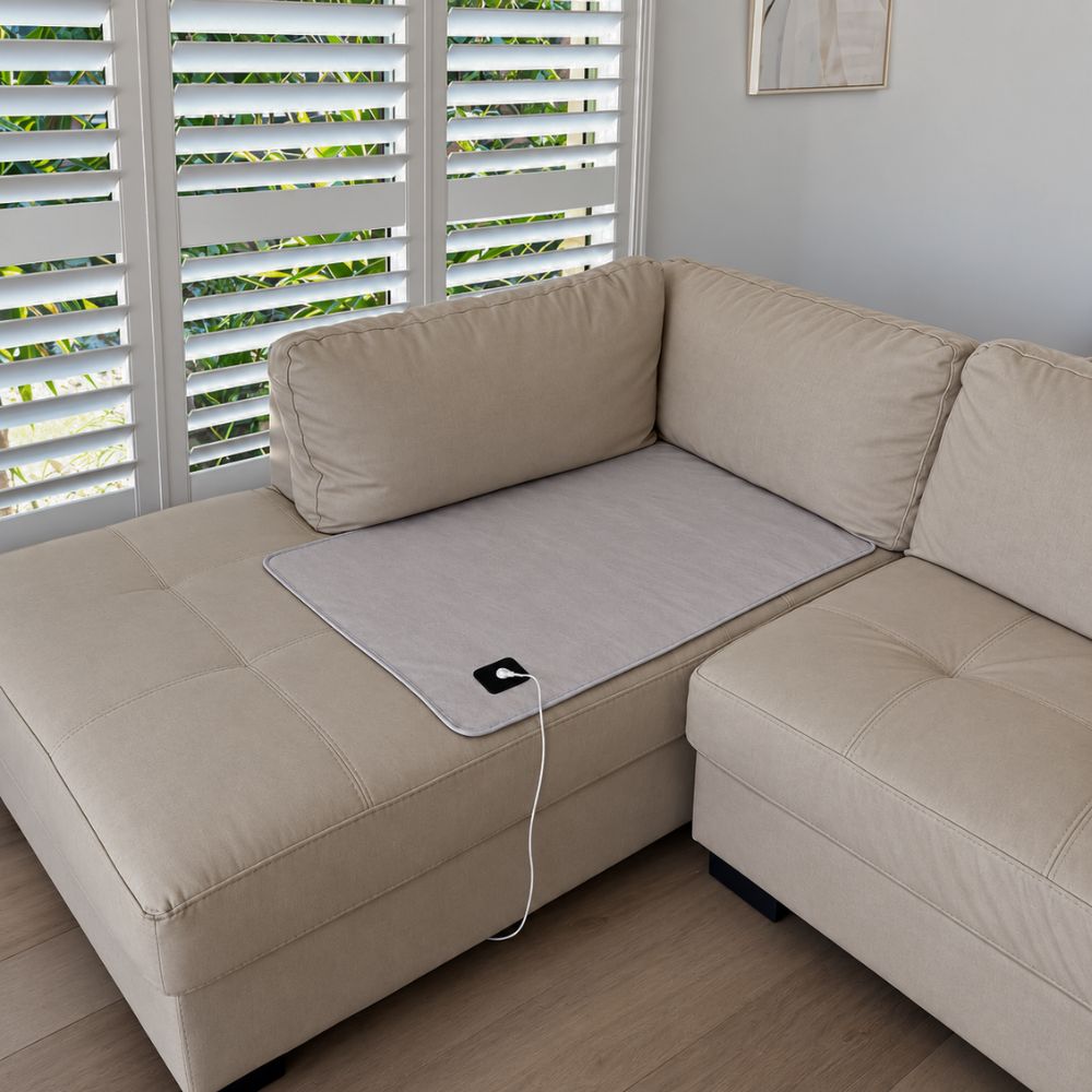 Grounding mat placed on a sofa for relaxing at home. Grounding mat placed on a sofa for relaxing at home.
