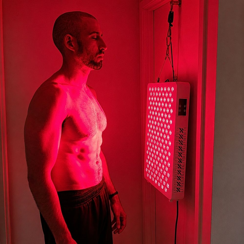 Man using ProX red light therapy panel. Man using ProX red light therapy panel.